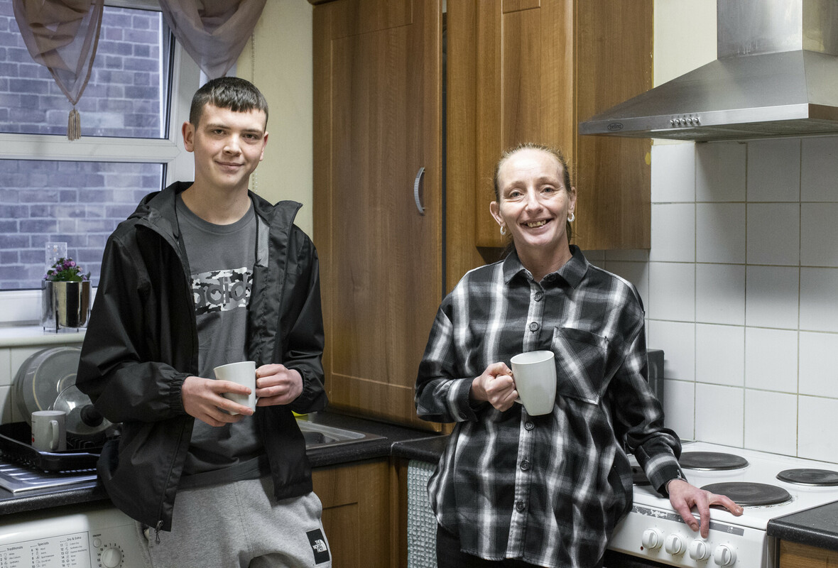 Homelessness across BCP. Two people back in housing in a kitchen.